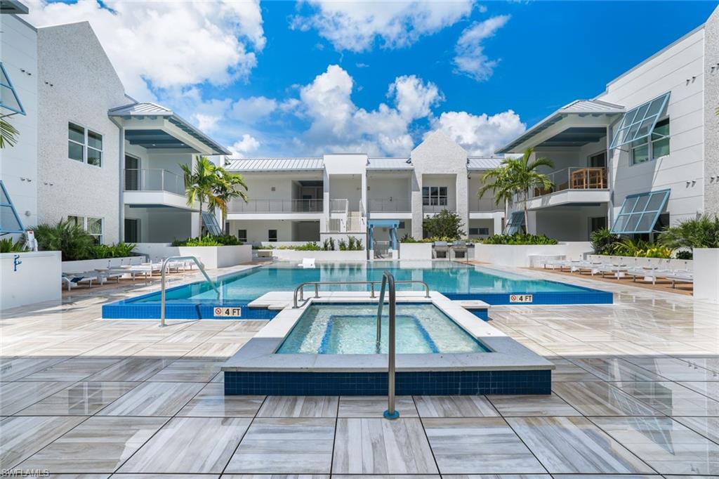 201 8th Street South, Unit 308 Naples, FL 34102 - Photo 25 of 28 a view of a patio with swimming pool table and chairs