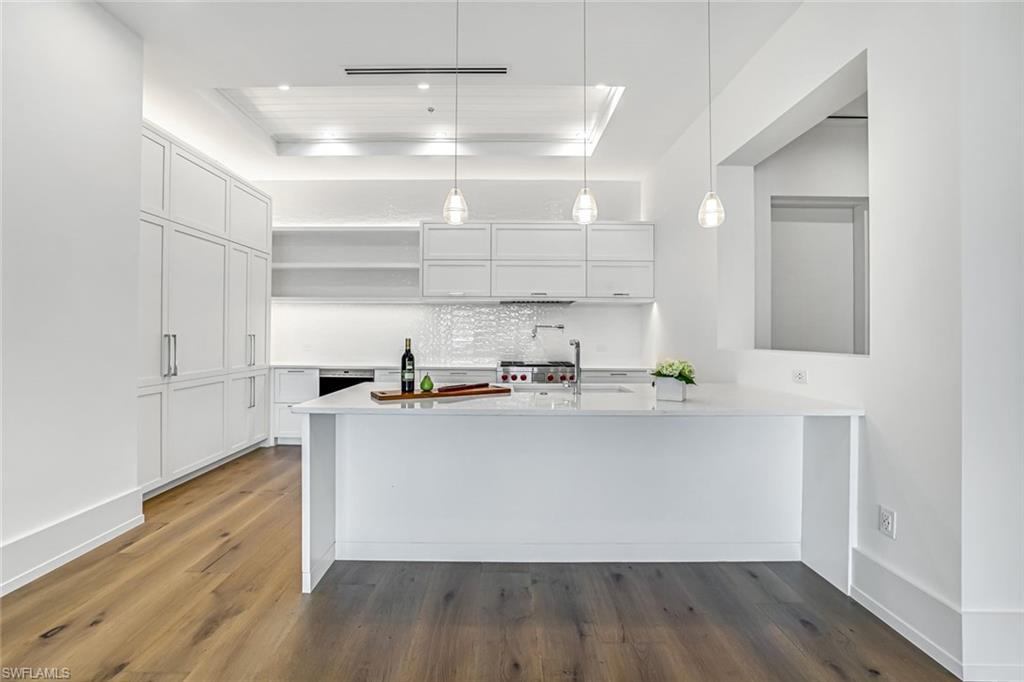 201 8th Street South, Unit 308 Naples, FL 34102 - Photo 4 of 28 a kitchen with stainless steel appliances a sink and cabinets