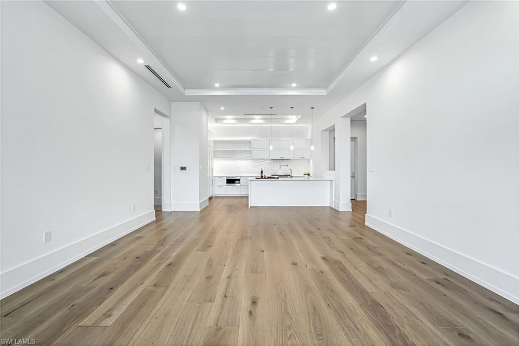 201 8th Street South, Unit 308 Naples, FL 34102 - Photo 10 of 28 a big room with wooden floor