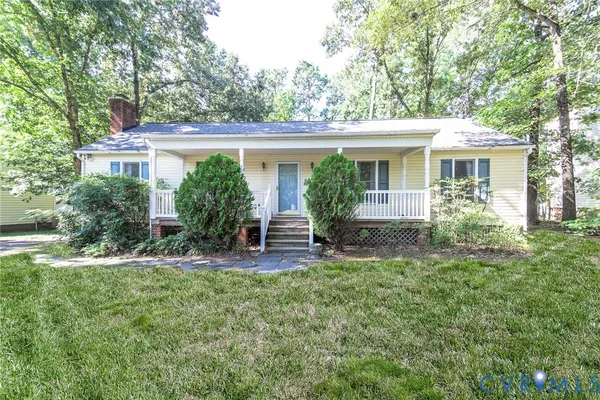 a view of a house with a yard and sitting area
