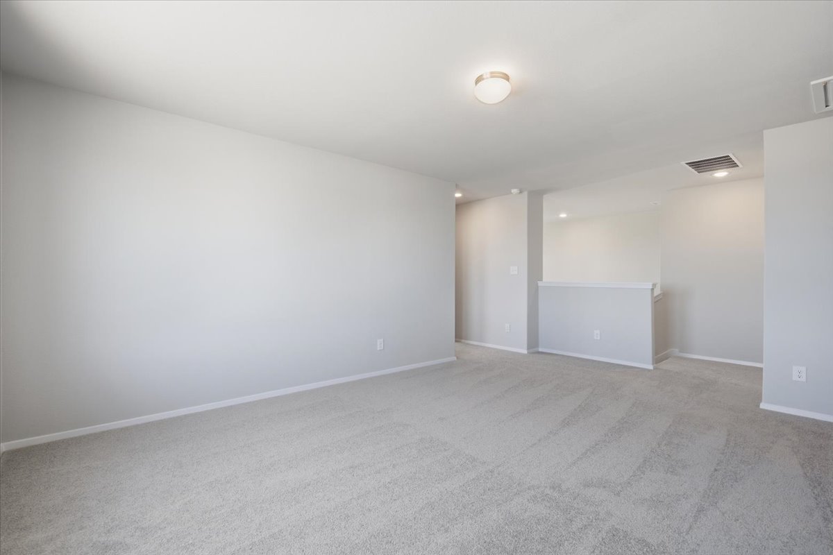 2714 Foss Road Manor, TX 78653 - Photo 22 of 34 Plush wall-to-wall carpeting and clean neutral walls define this versatile upper-level living space.