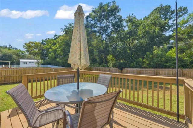 a view of a chair and table on the deck