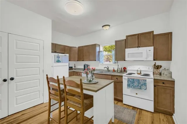 a kitchen with a table chairs refrigerator and cabinets