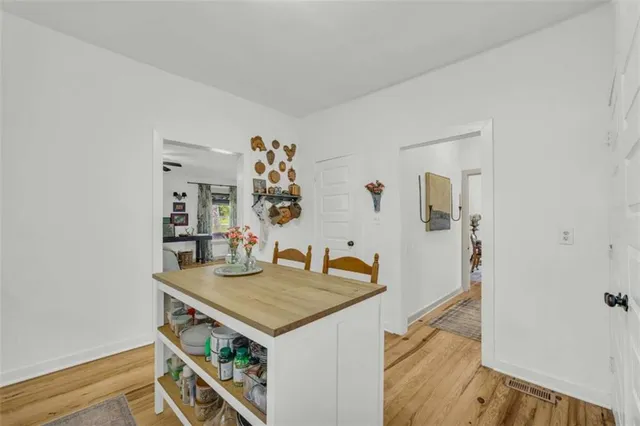 a view of a kitchen area with furniture and wooden floor