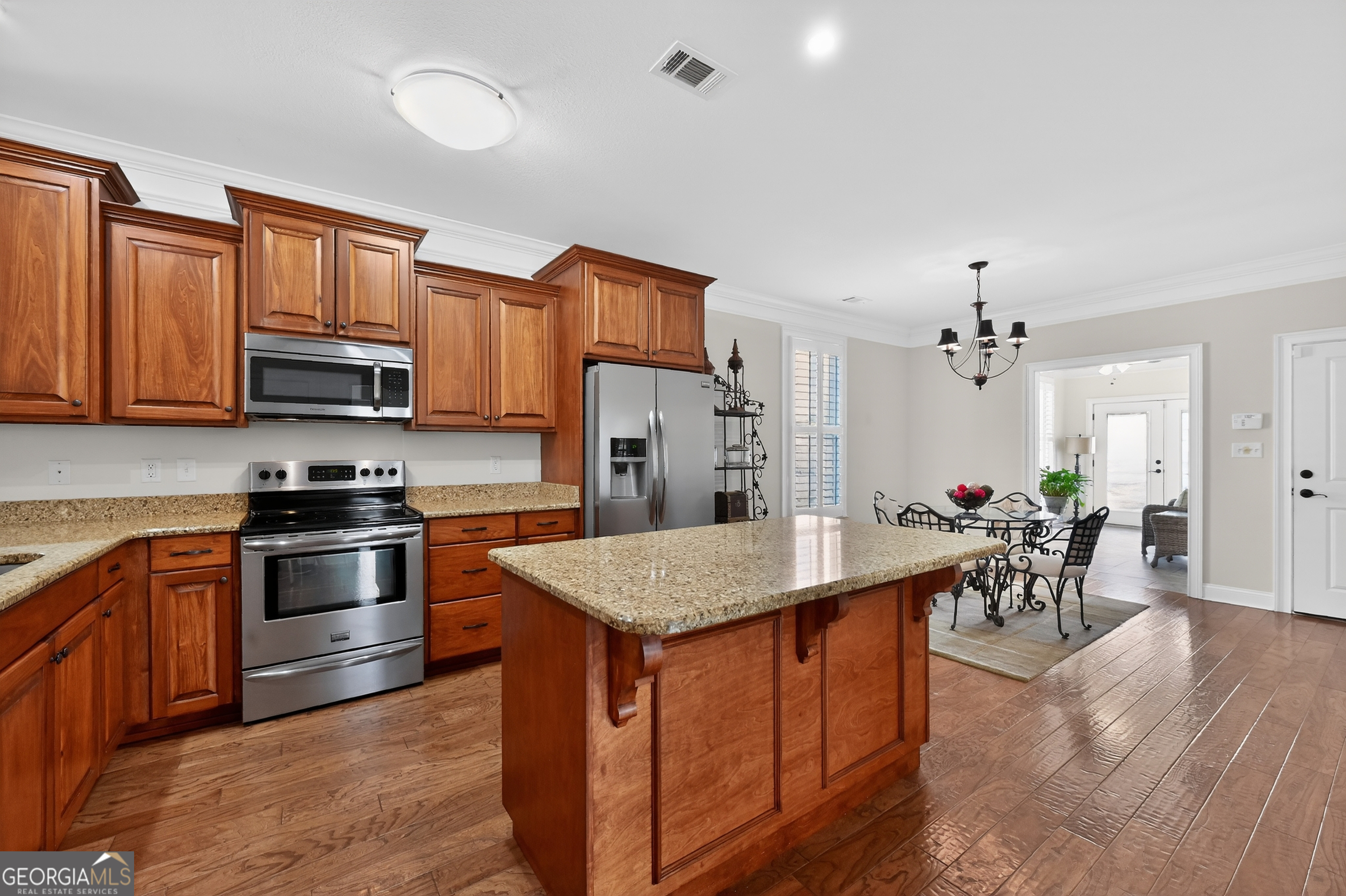 1617 Red Oak Lane Albany, GA 31701 - Photo 12 of 36 a kitchen with stainless steel appliances granite countertop a stove top oven a sink dishwasher and a refrigerator with wooden floor