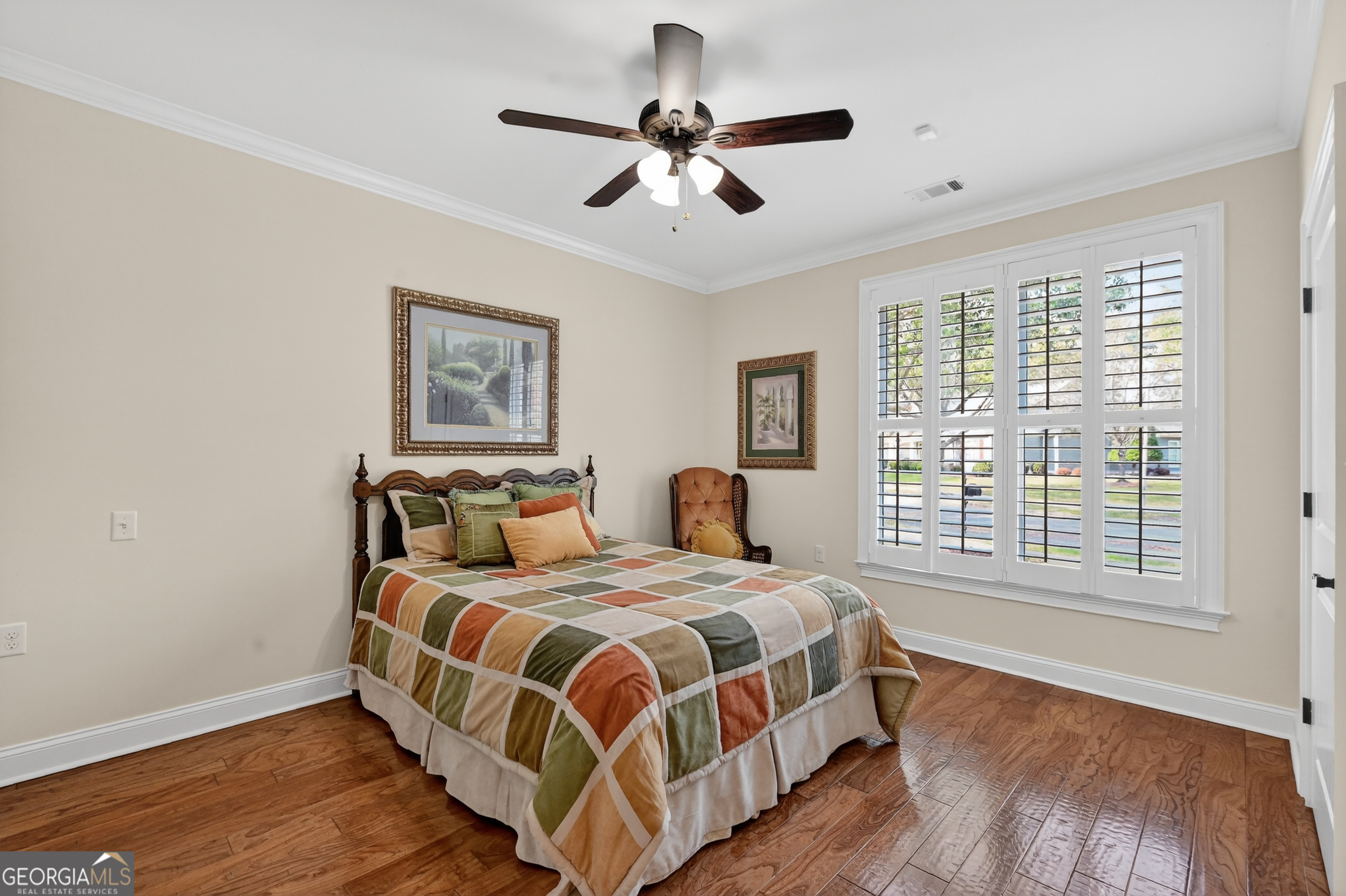 1617 Red Oak Lane Albany, GA 31701 - Photo 23 of 36 a bedroom with a large bed chandelier and a window