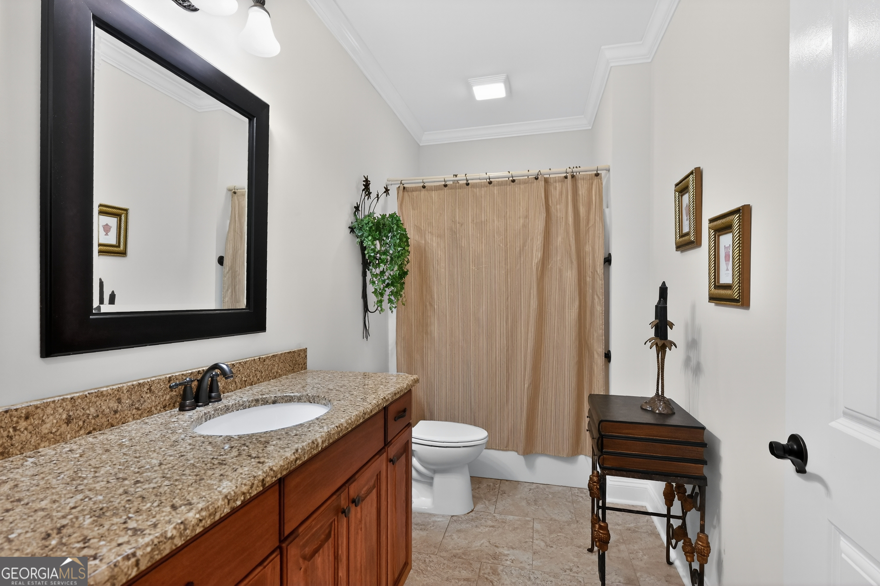 1617 Red Oak Lane Albany, GA 31701 - Photo 26 of 36 a bathroom with a granite countertop sink a toilet and a mirror