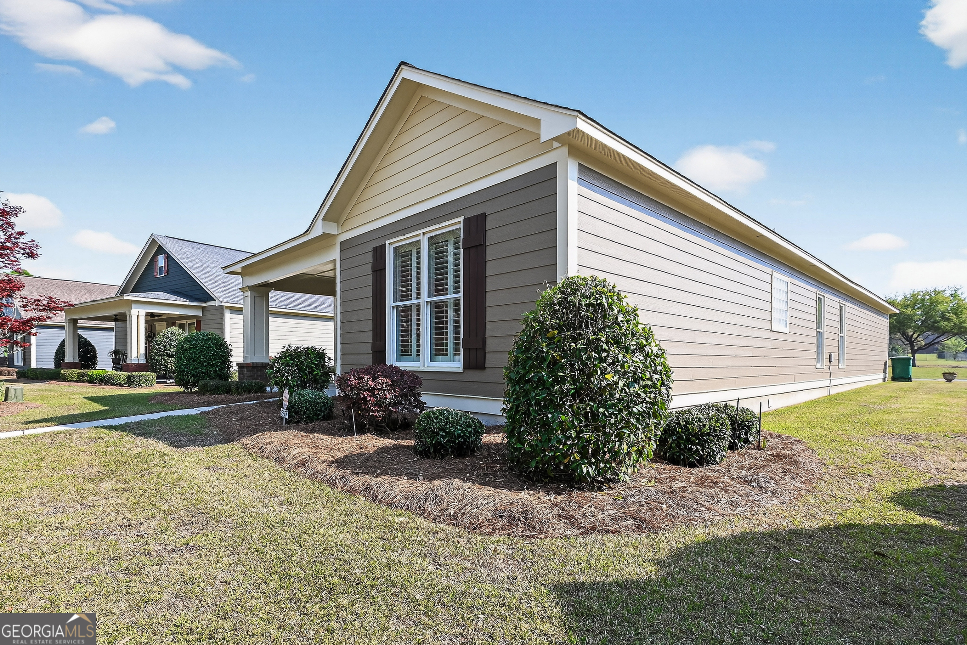 1617 Red Oak Lane Albany, GA 31701 - Photo 5 of 36 a view of a white house next to a yard with potted plants