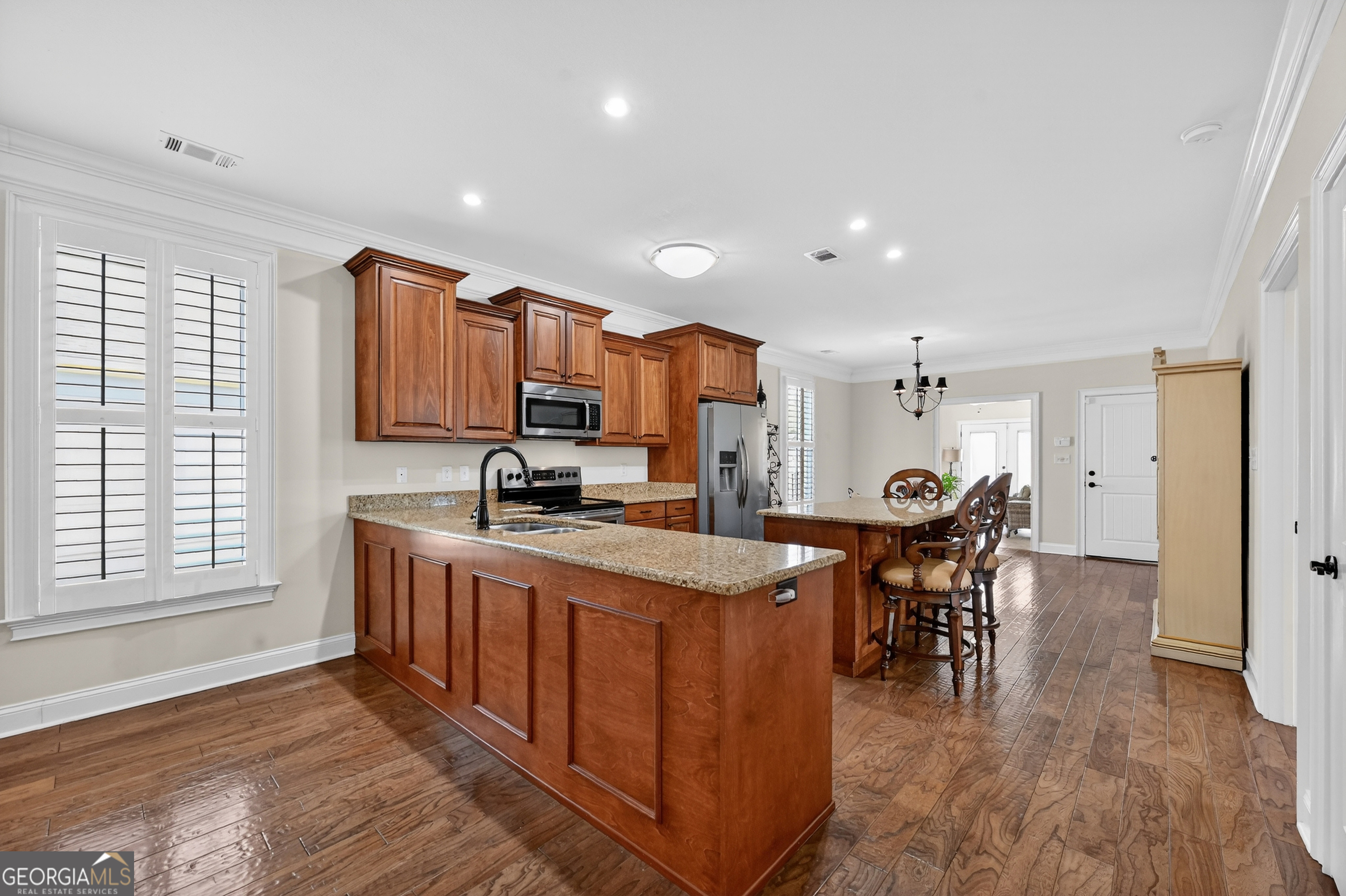 1617 Red Oak Lane Albany, GA 31701 - Photo 8 of 36 a large kitchen with kitchen island a sink table and chairs