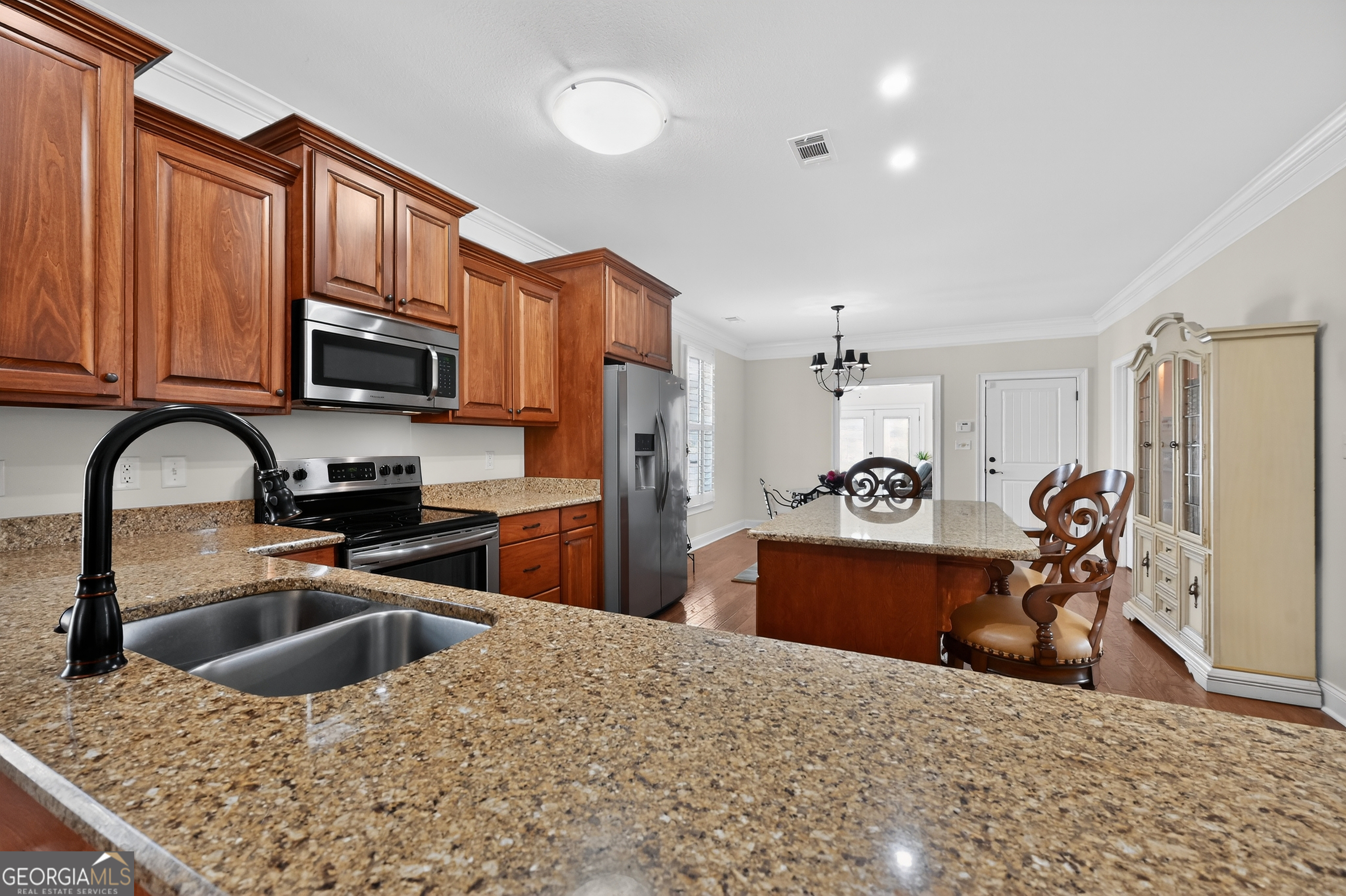 1617 Red Oak Lane Albany, GA 31701 - Photo 10 of 36 a kitchen with stainless steel appliances granite countertop a sink dishwasher stove top oven and refrigerator with wooden floor