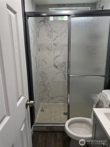 a bathroom with a shower and a toilet