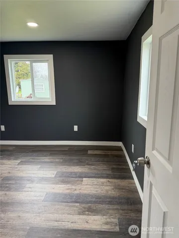a view of a livingroom with an empty space and a window