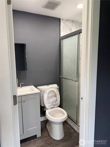 a white toilet sitting next to a bathroom sink