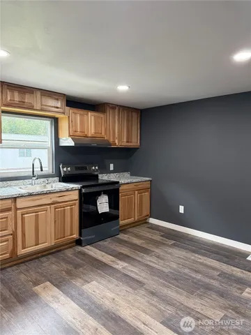 a kitchen with stainless steel appliances granite countertop a stove a sink and a granite counter tops