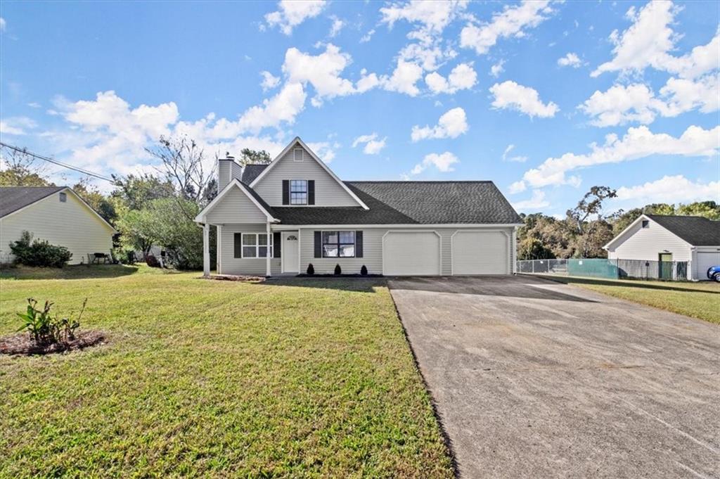 a front view of a house with garden