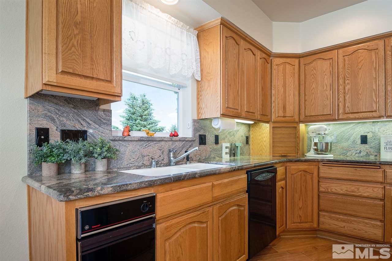 796 Foothill Road Gardnerville, NV 89460 - Photo 22 of 38 a kitchen with stainless steel appliances granite countertop a sink and a counter space