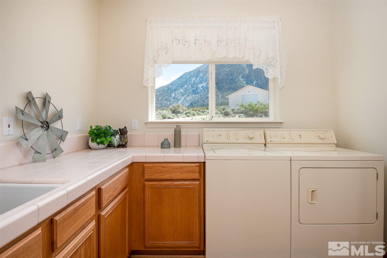796 Foothill Road Gardnerville, NV 89460 - Photo 23 of 38 a bathroom with a sink and a large mirror