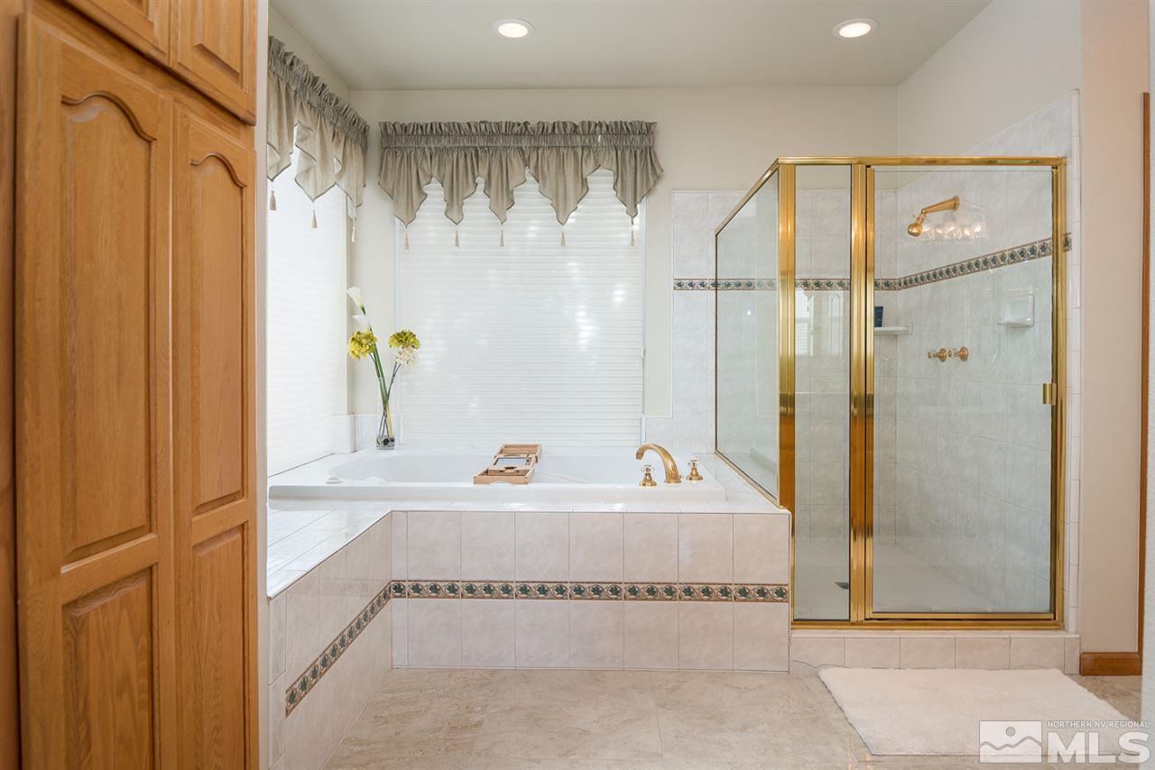 796 Foothill Road Gardnerville, NV 89460 - Photo 26 of 38 a bathroom with a tub a sink and a shower