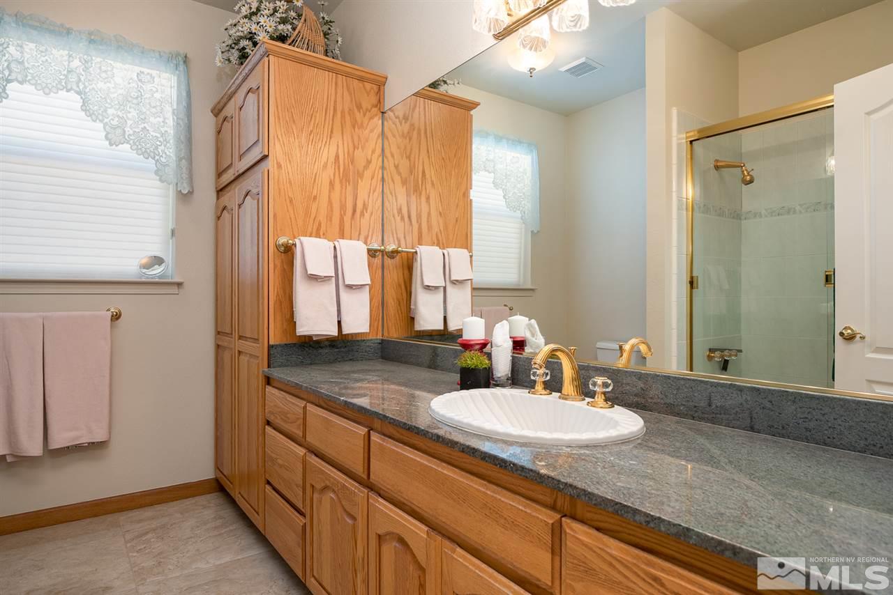796 Foothill Road Gardnerville, NV 89460 - Photo 28 of 38 a bathroom with a granite countertop sink and a mirror
