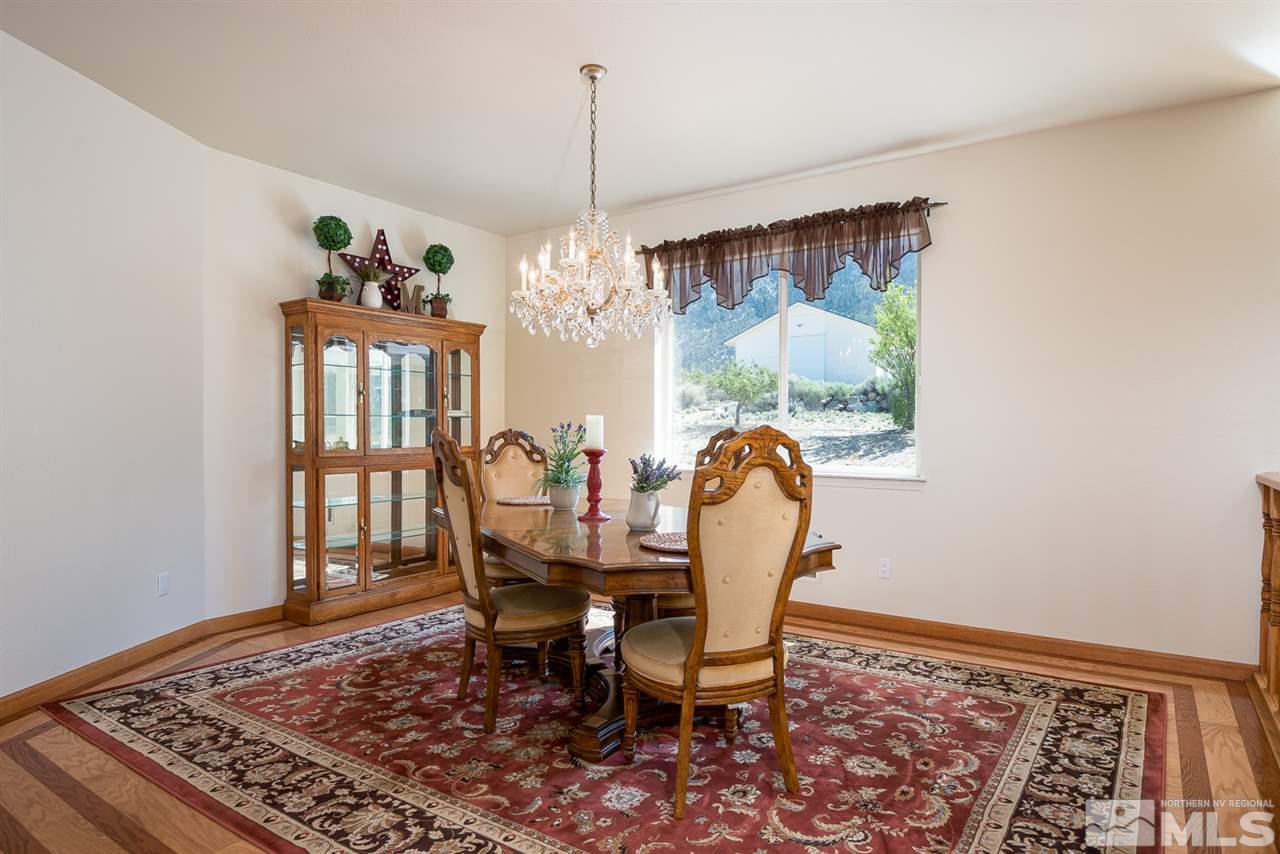 796 Foothill Road Gardnerville, NV 89460 - Photo 34 of 38 a dining room with furniture a rug and a chandelier