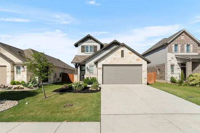 a front view of a house with a yard and outdoor seating