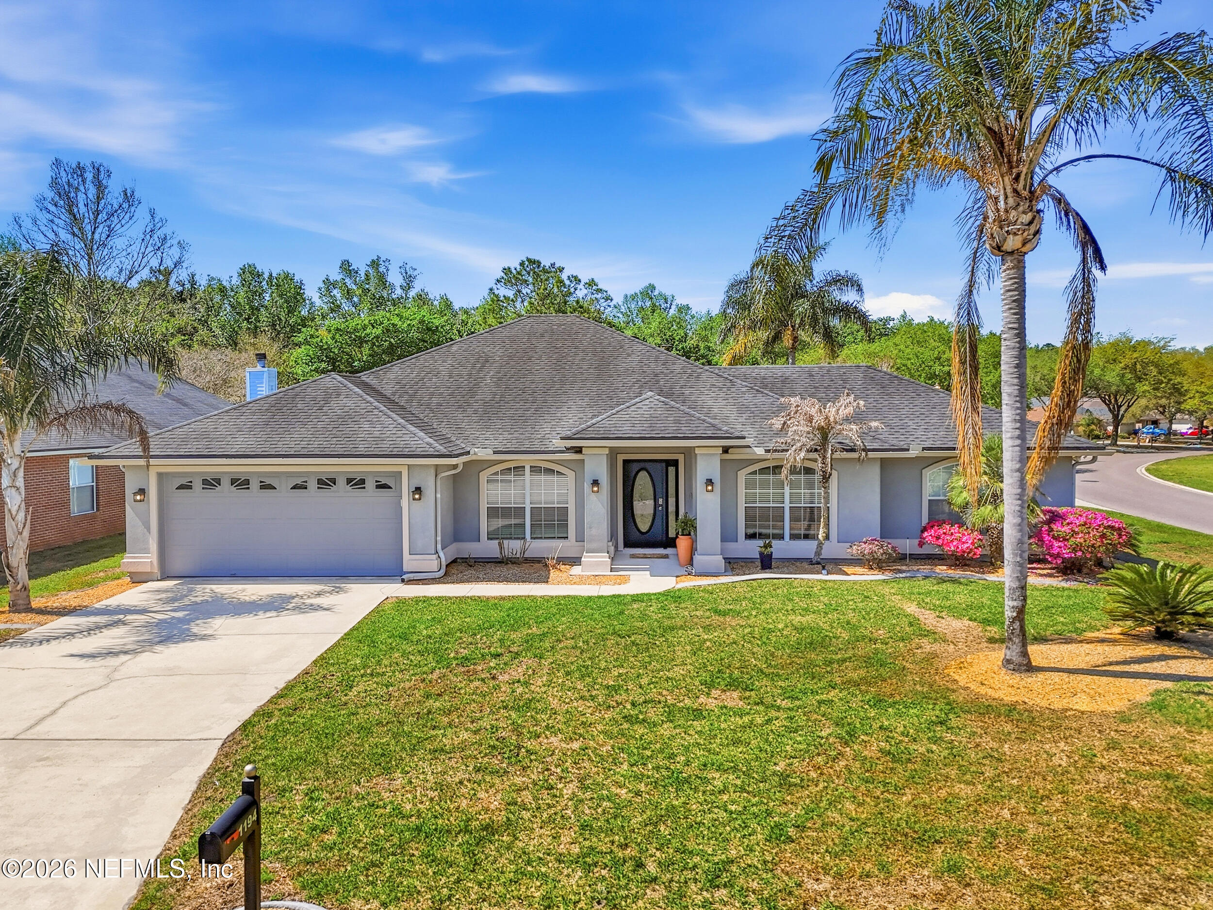 1194 Ardmore Street St. Augustine, FL 32092 - Photo 1 of 48 a front view of a house with a yard and palm trees