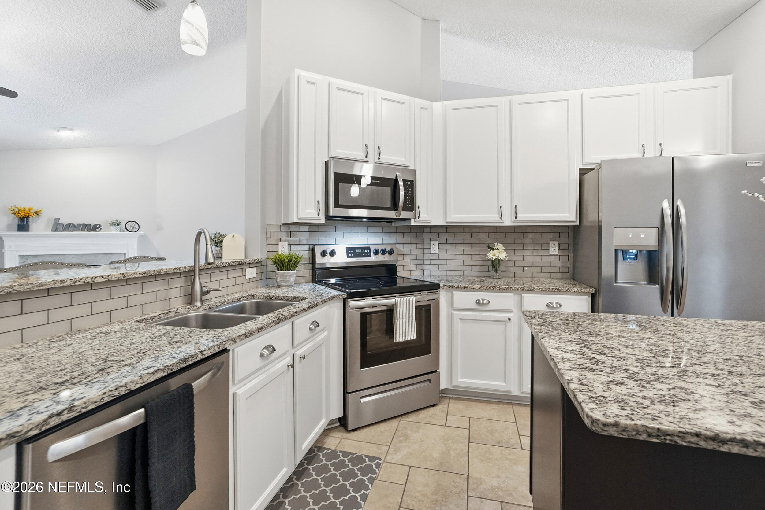 1194 Ardmore Street St. Augustine, FL 32092 - Photo 13 of 48 a kitchen with stainless steel appliances granite countertop a sink stove and refrigerator