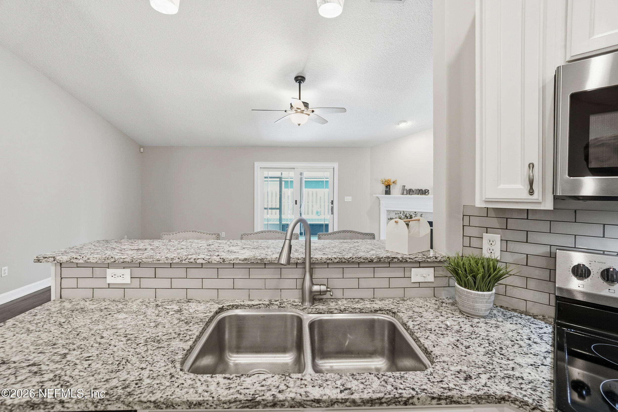 1194 Ardmore Street St. Augustine, FL 32092 - Photo 14 of 48 a kitchen with a sink a counter space and cabinets