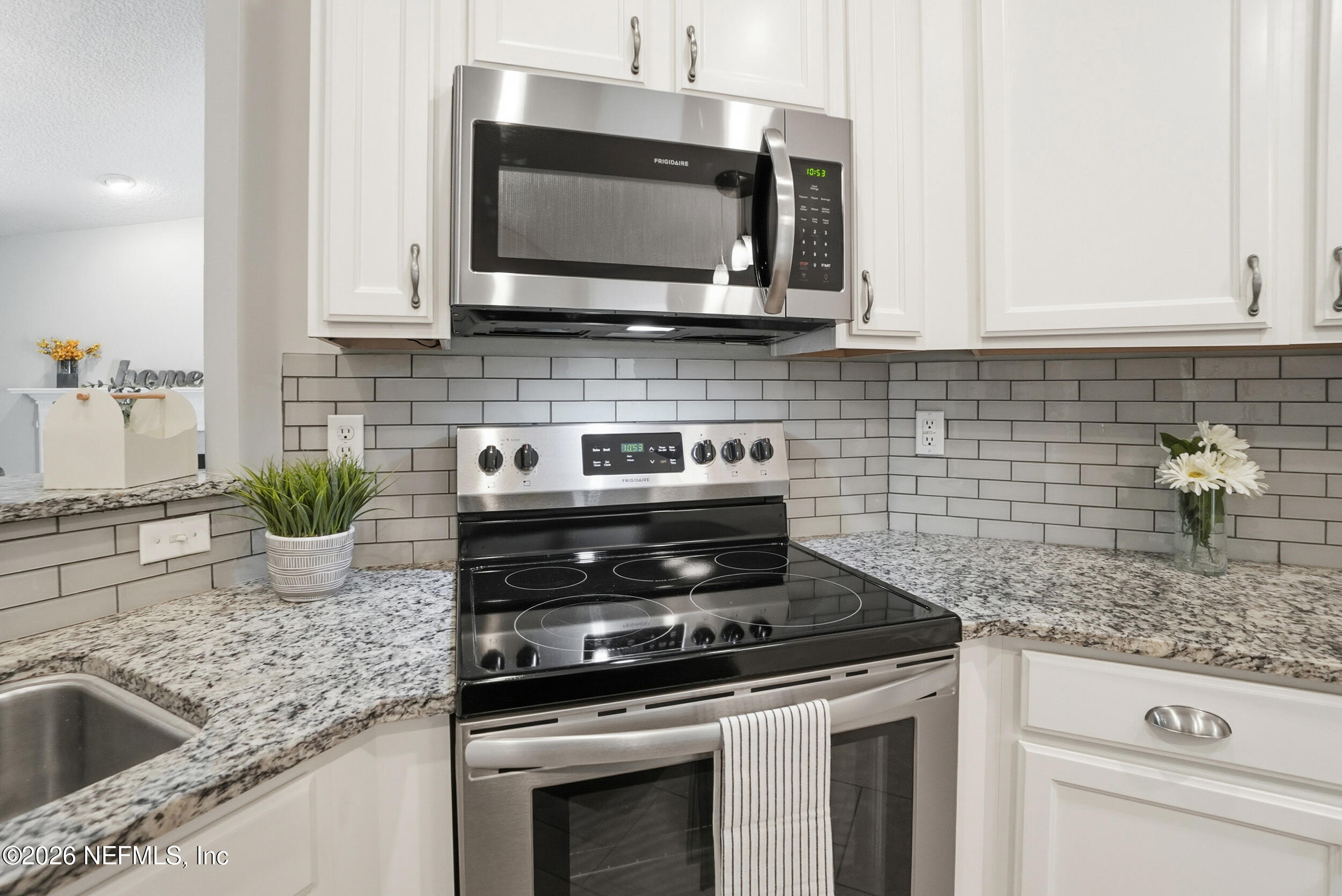 1194 Ardmore Street St. Augustine, FL 32092 - Photo 15 of 48 a kitchen with stainless steel appliances granite countertop a sink stove and microwave