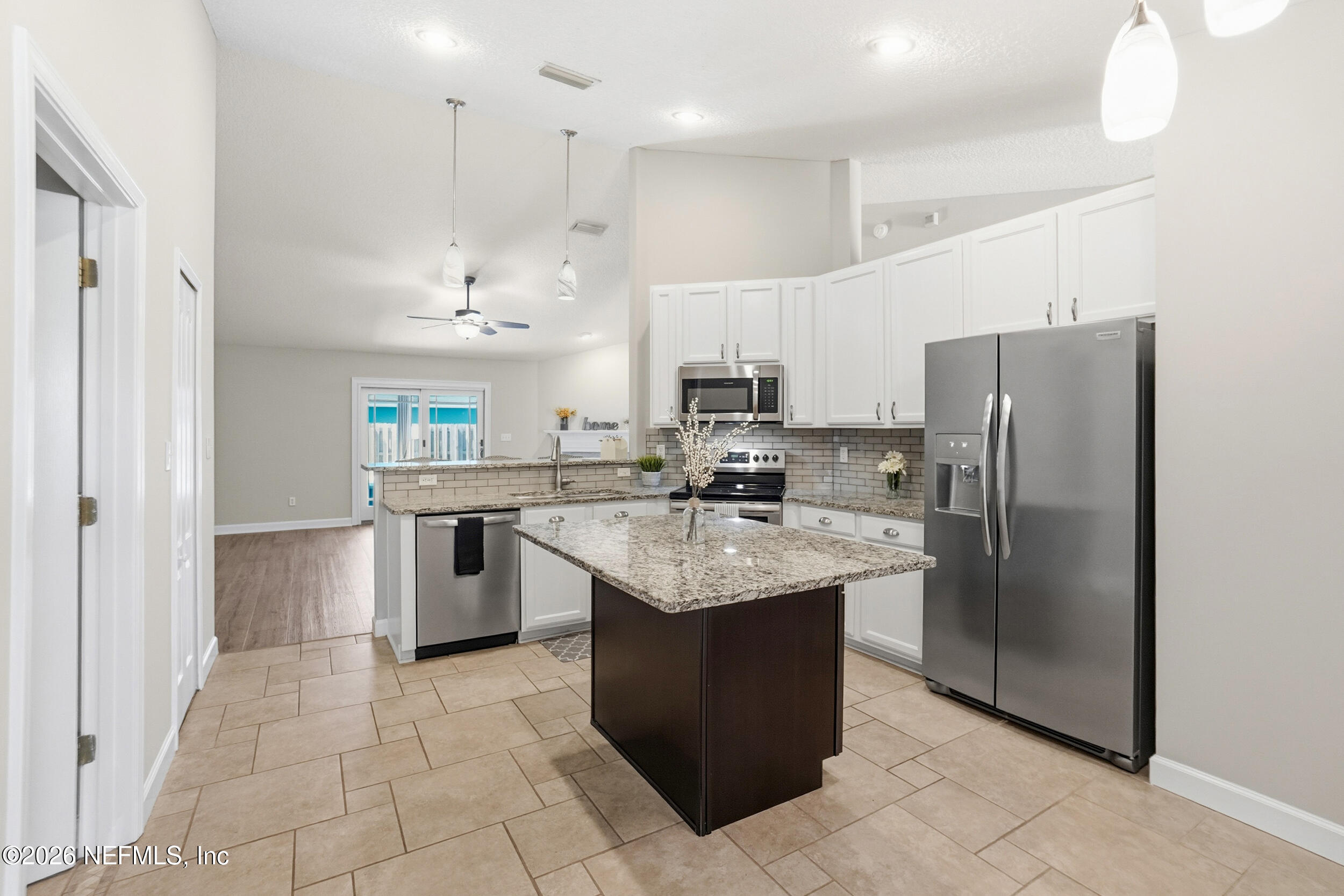 1194 Ardmore Street St. Augustine, FL 32092 - Photo 18 of 48 a kitchen with a sink a counter top space stainless steel appliances and cabinets