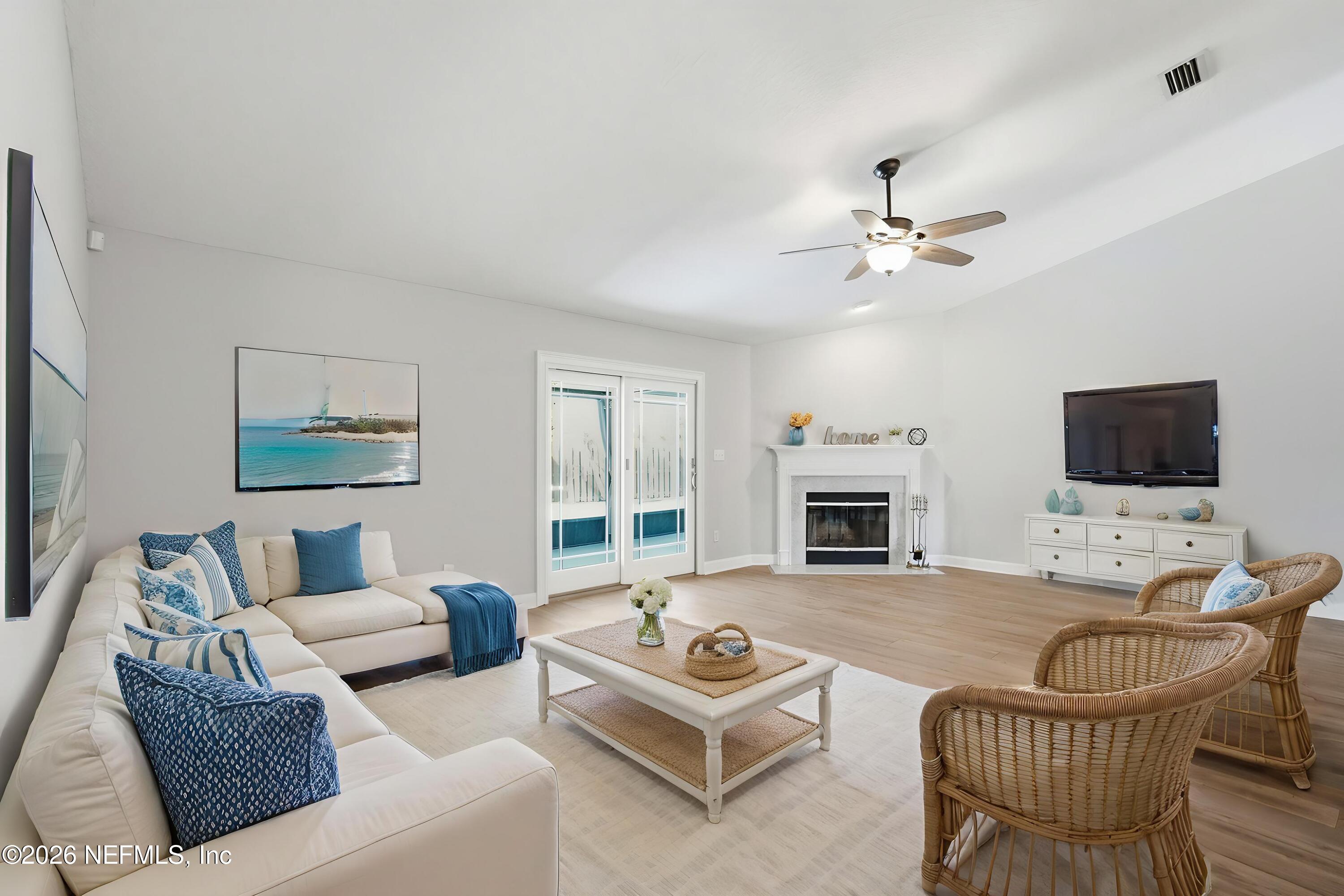 1194 Ardmore Street St. Augustine, FL 32092 - Photo 20 of 48 a living room with furniture a fireplace and a flat screen tv