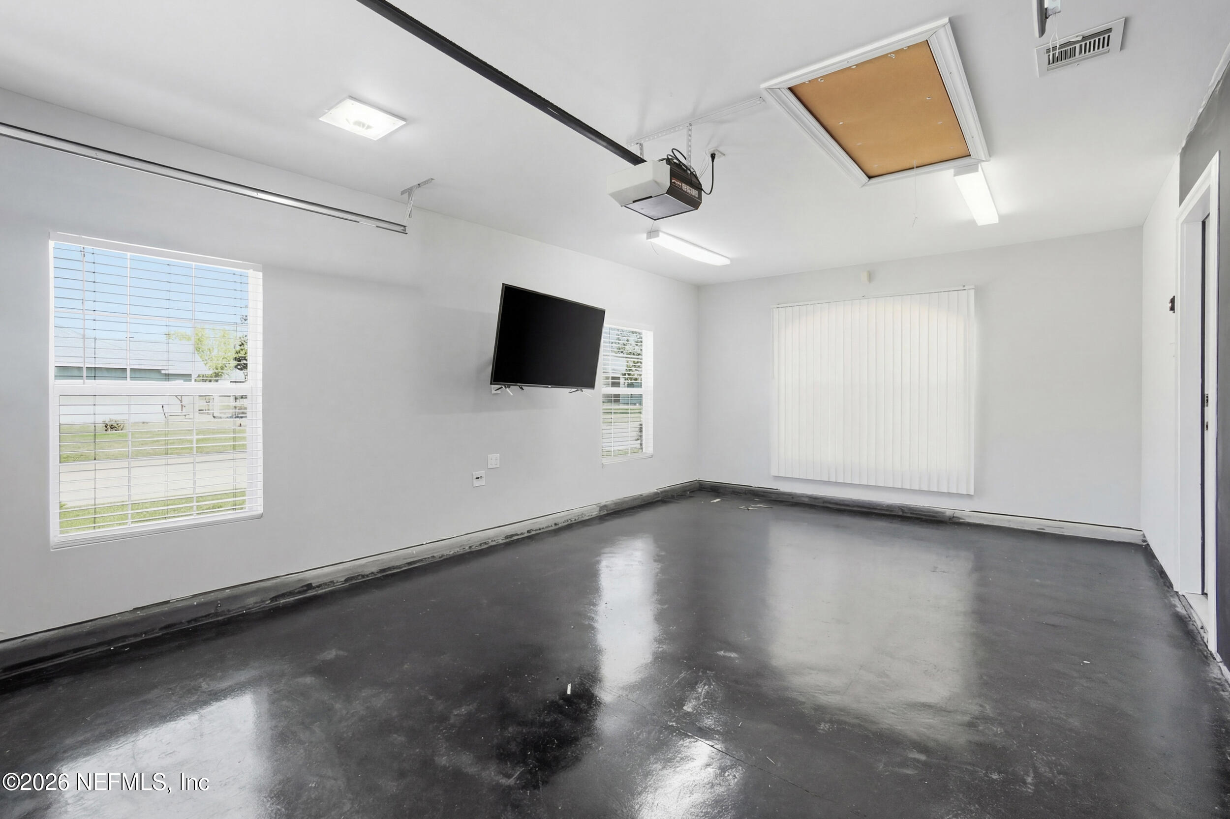1194 Ardmore Street St. Augustine, FL 32092 - Photo 34 of 48 a view of a livingroom with wooden floor and a flat screen tv