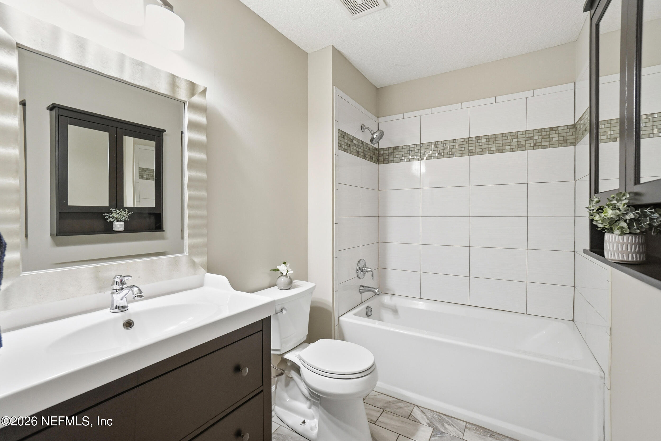 1194 Ardmore Street St. Augustine, FL 32092 - Photo 9 of 48 a bathroom with a sink toilet tub and shower