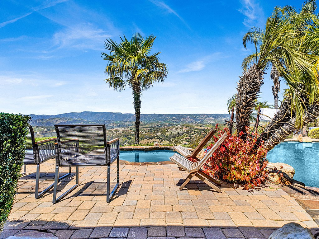 25900 Carancho Road Temecula, CA 92590 - Photo 11 of 58 a view of a terrace with wooden floor and a bench