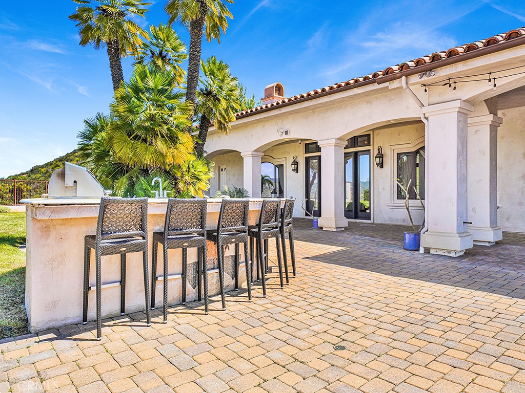25900 Carancho Road Temecula, CA 92590 - Photo 18 of 58 a view of a patio with table and chairs and wooden fence
