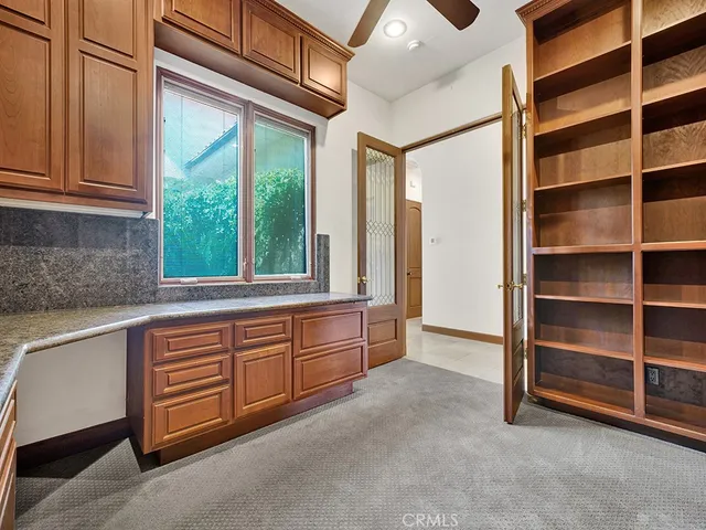 a view of kitchen with stainless steel appliances granite countertop a refrigerator and a stove