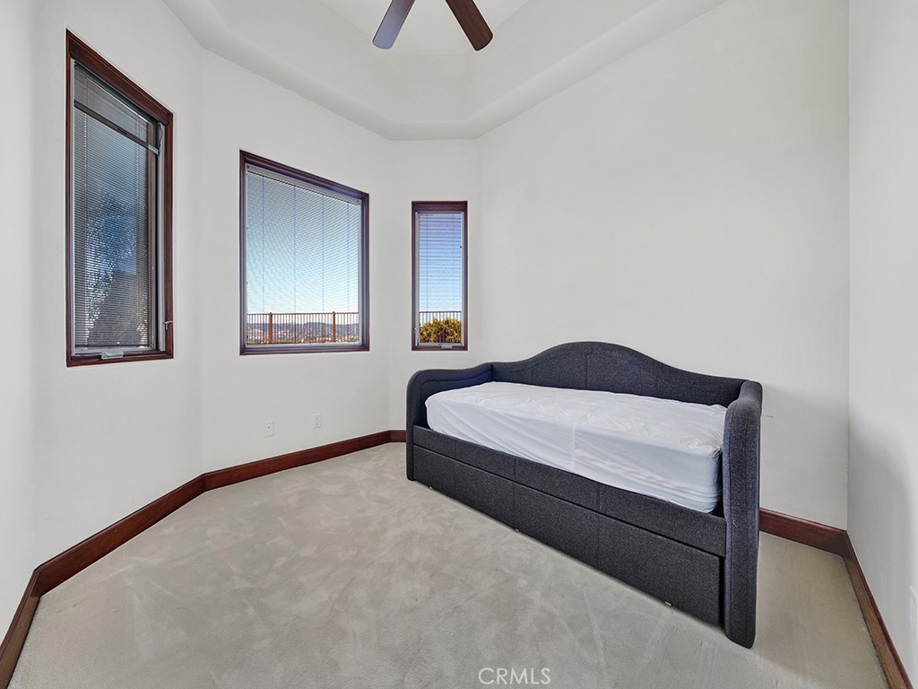 25900 Carancho Road Temecula, CA 92590 - Photo 33 of 58 a bedroom with a bed and a chandelier