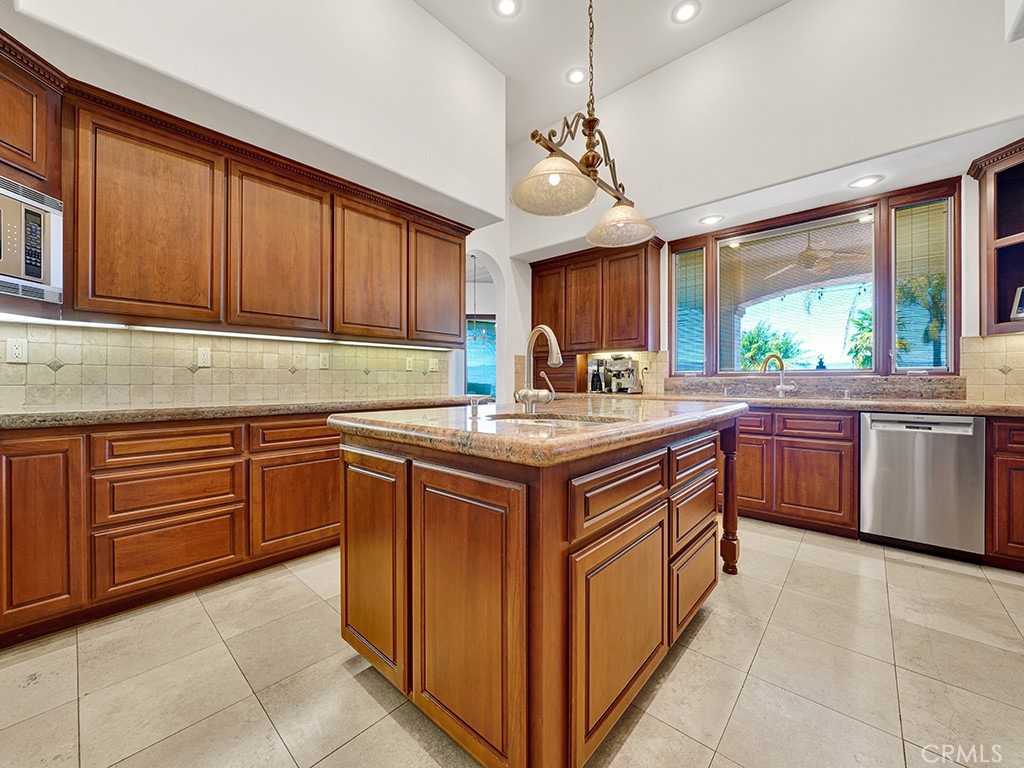 25900 Carancho Road Temecula, CA 92590 - Photo 46 of 58 a kitchen with stainless steel appliances granite countertop a sink stove and cabinets