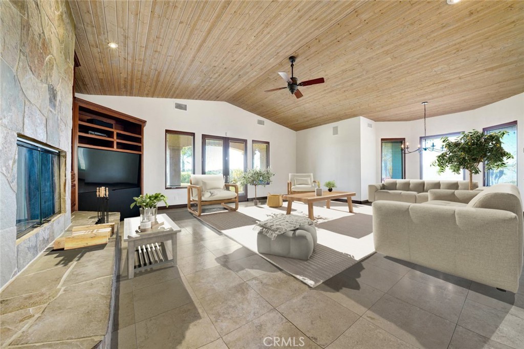 25900 Carancho Road Temecula, CA 92590 - Photo 50 of 58 a living room with couches a flat screen tv and kitchen view
