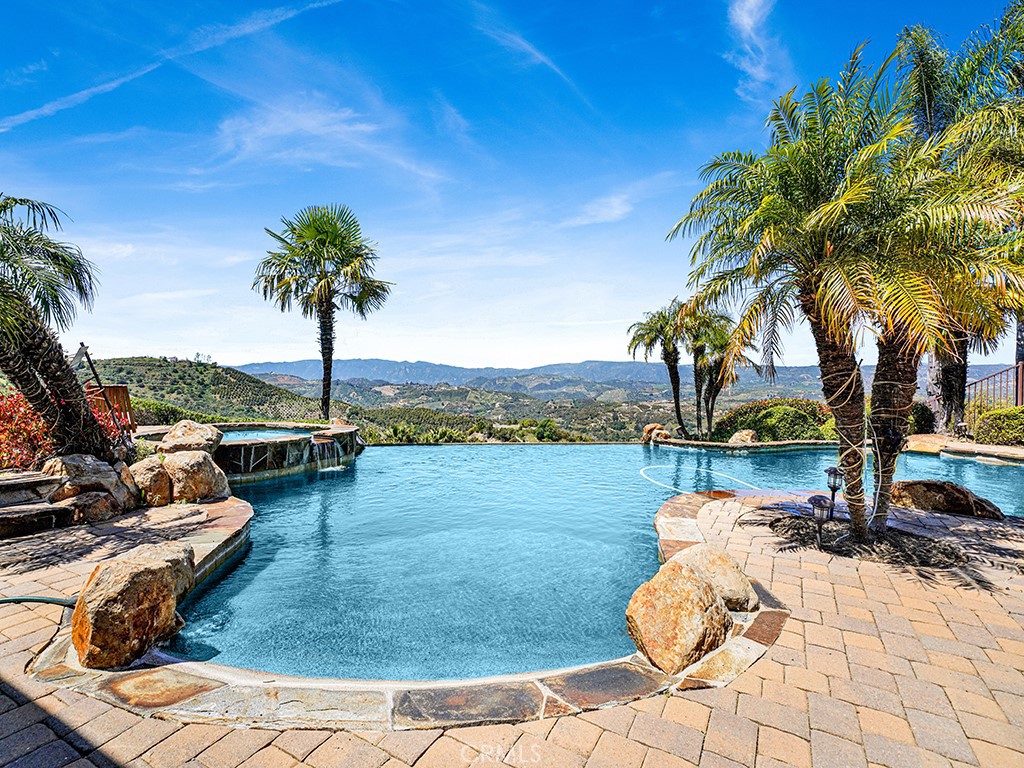 25900 Carancho Road Temecula, CA 92590 - Photo 7 of 58 a view of a swimming pool and lounge chair