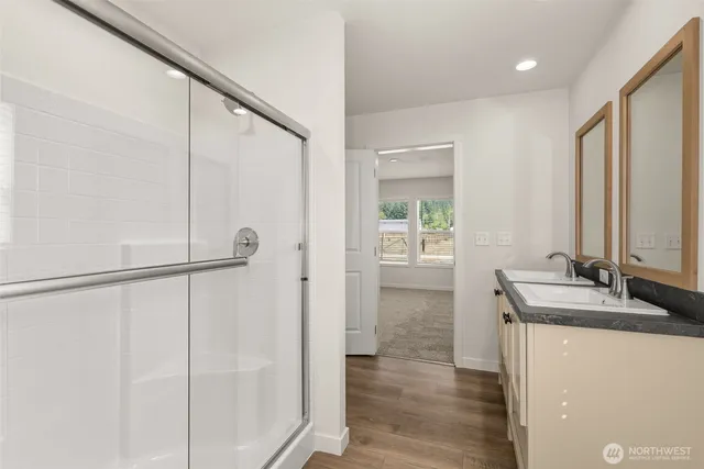 a bathroom with a granite countertop sink and a mirror