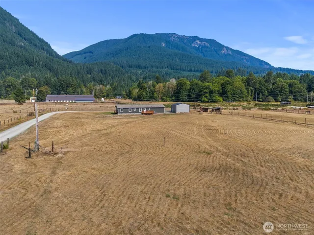 a view of a house with a yard and mountain view