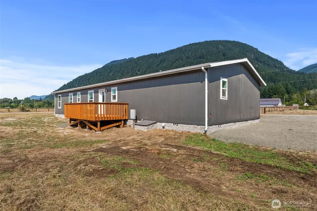 a backyard of a house with wooden fence and a big yard