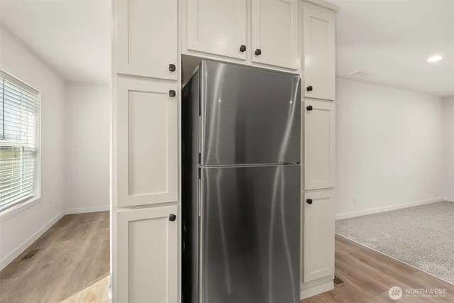 a view of wooden cabinets and refrigerator