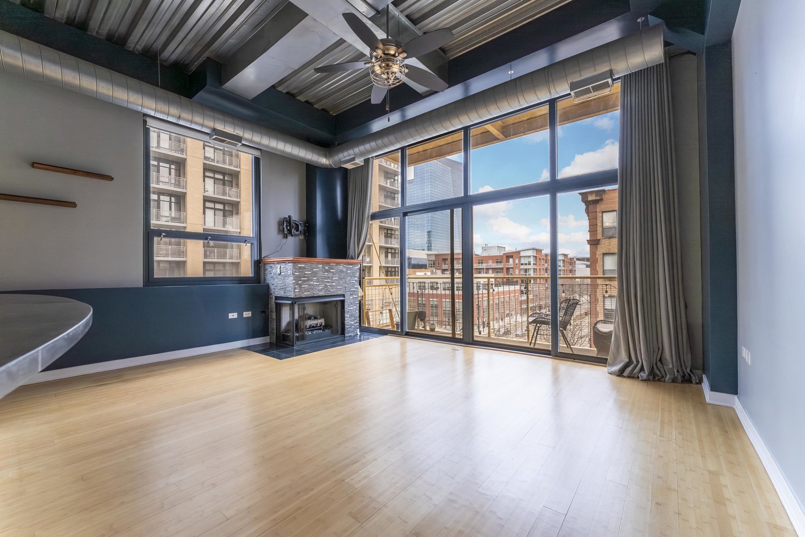 1910 South Indiana Avenue, Unit 421 Chicago, IL 60616 - Photo 5 of 28 a view of an empty room with wooden floor and a window
