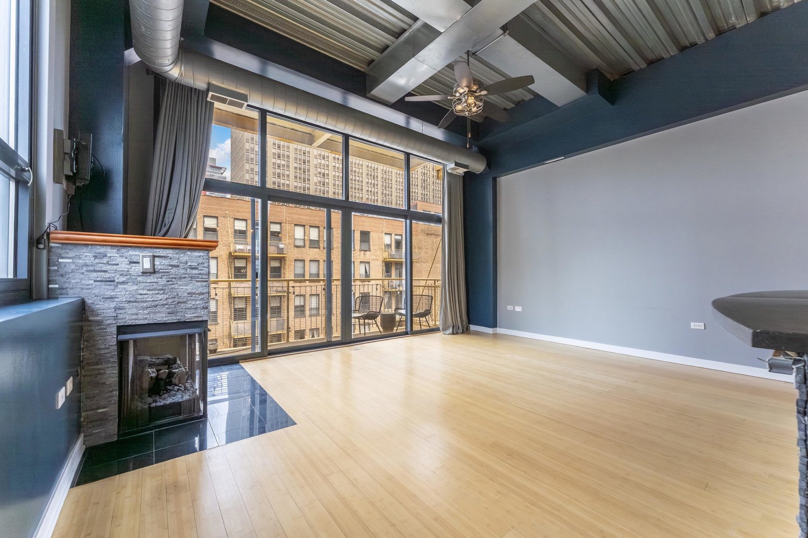 1910 South Indiana Avenue, Unit 421 Chicago, IL 60616 - Photo 6 of 28 a view of an empty room with a fireplace and a window