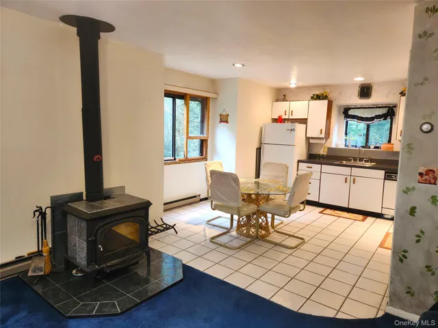 a living room with furniture a fireplace and large windows