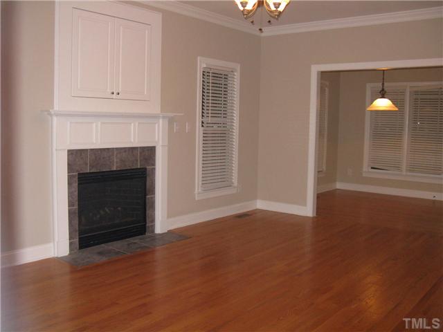 Great  sized family room with hardwood floors, crown moulding, tiled, gas log fireplace and covered TV niche.
