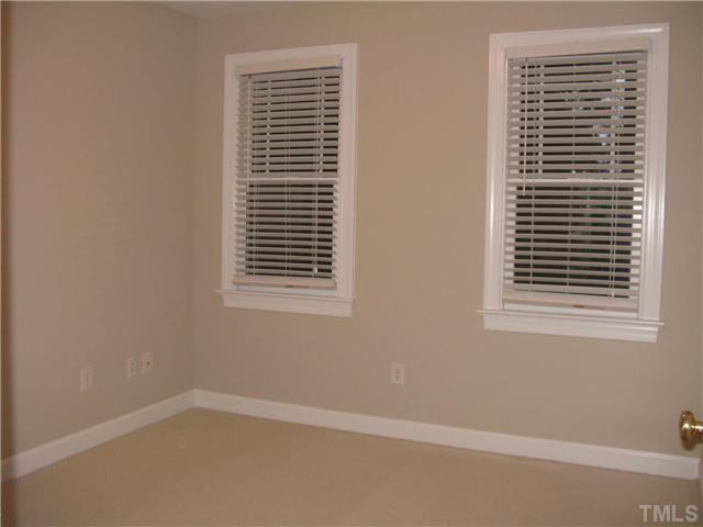 209 Rushing Wind Way Apex, NC 27502 - Photo 9 of 16 All windows are covered with two inch faux wood blinds.