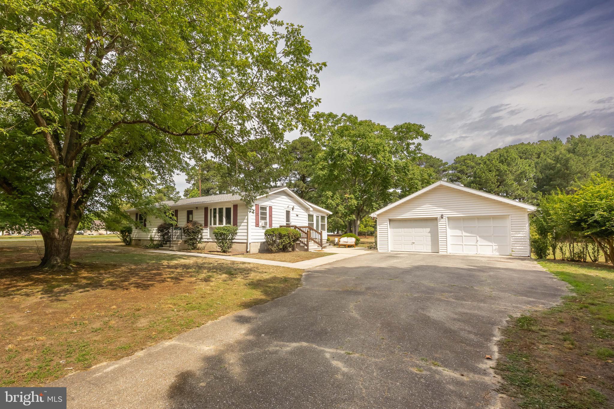 11060 Roland Parks Road Chance, MD 21821 - Photo 2 of 60 a view of a large house with a big yard and large trees